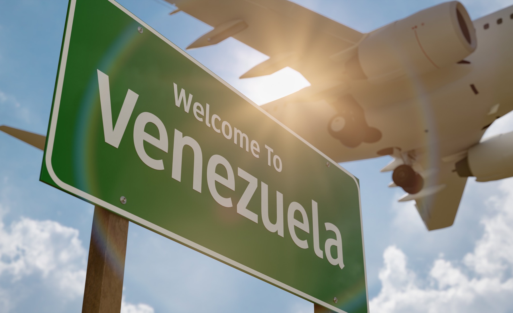 Welcome to Venezuela sign with an aircraft overhead
